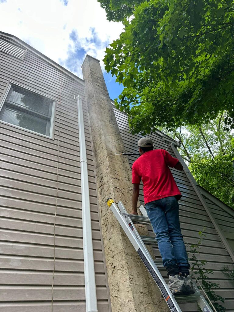 A chimmney sweep preforming an inspection on a chimmey