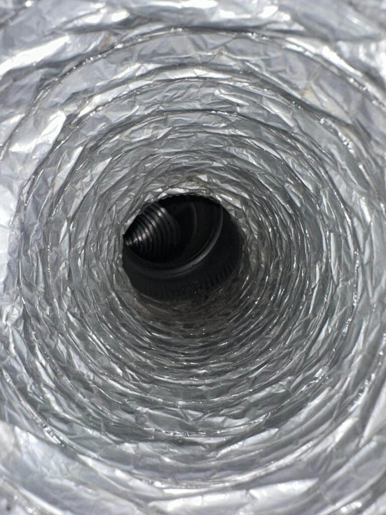 A dryer vent after being swept and serviced by a chimney sweep